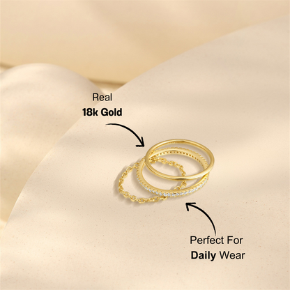 Close-up view of a gold-plated 925 sterling silver 3-piece ring set featuring zirconia stones on soft beige background