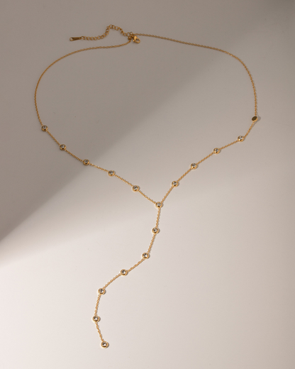 Gold necklace on a beige background