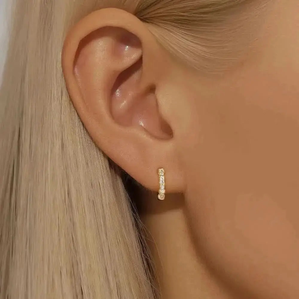 Dainty Crystal-Studded Hoops – These gold hoops with tiny crystals are the perfect blend of elegance and simplicity, ideal for stacking or wearing alone.
