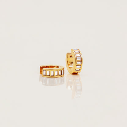 Elegant gold hoop earrings reflecting soft light