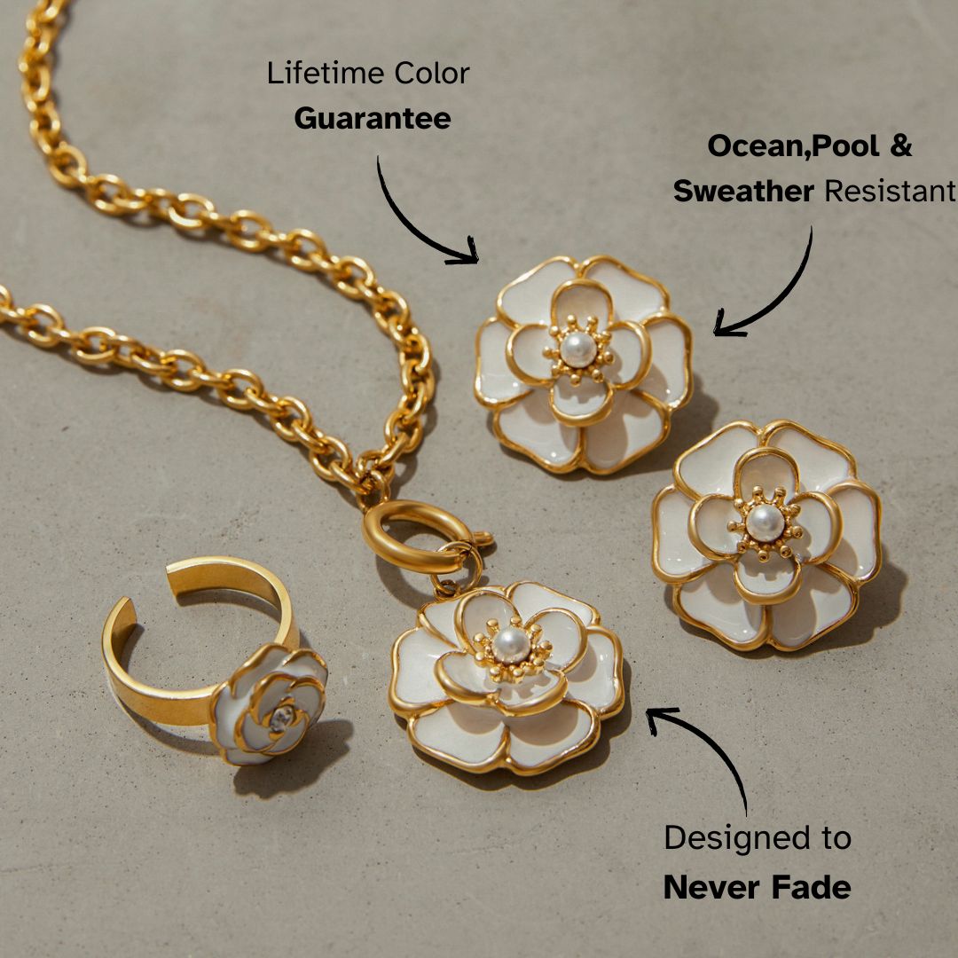 Studio shot of round white enamel and pearl floral earrings with gold outline