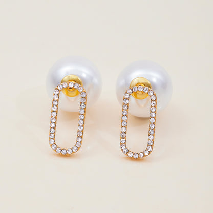 Elegant gold and pearl drop earrings on neutral background