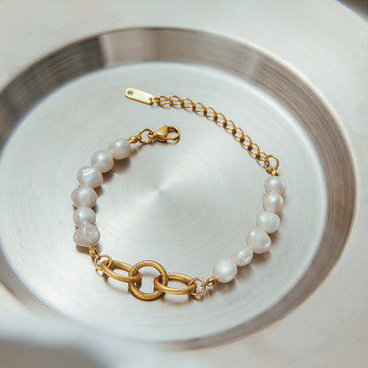 Pearl and gold bracelet displayed in a silver-toned serving tray