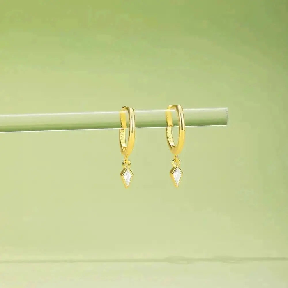 Elegant gold hoop earrings with a subtle diamond-shaped pendant. Perfect for any occasion.