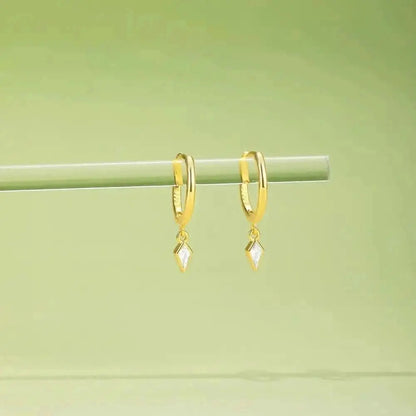 Elegant gold hoop earrings with a subtle diamond-shaped pendant. Perfect for any occasion.