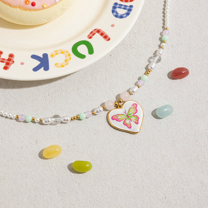 Waterproof beaded necklace with butterfly heart charm close-up