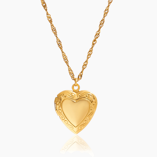 Gold heart-shaped necklace on a white background