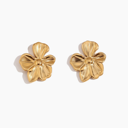 Gold floral earrings on a white background