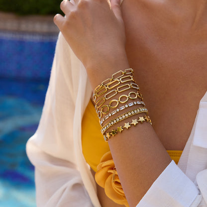 Model resting hand on a table, white crystal bracelet catching the light_MiFJewelry