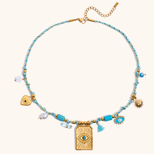 Close-up of waterproof boho necklace with evil eye and sun charms