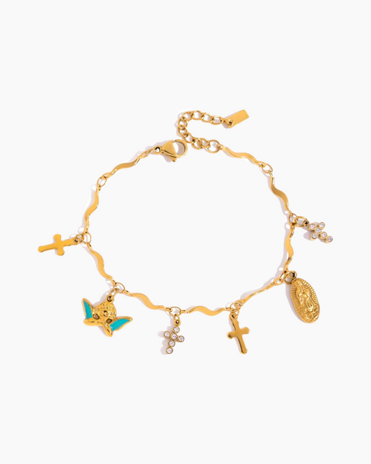 Gold bracelet with various charms on a white background