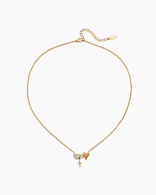 Gold necklace with heart and star pendant on a white background