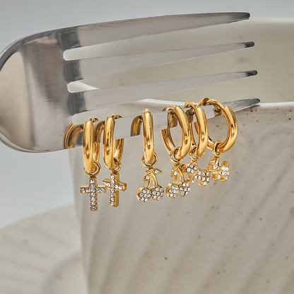 Gold cherry earrings hanging on silver fork for aesthetic flat lay_MiFJewelry