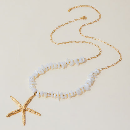Full flat-lay image of beach necklace with irregular white beads and gold starfish charm