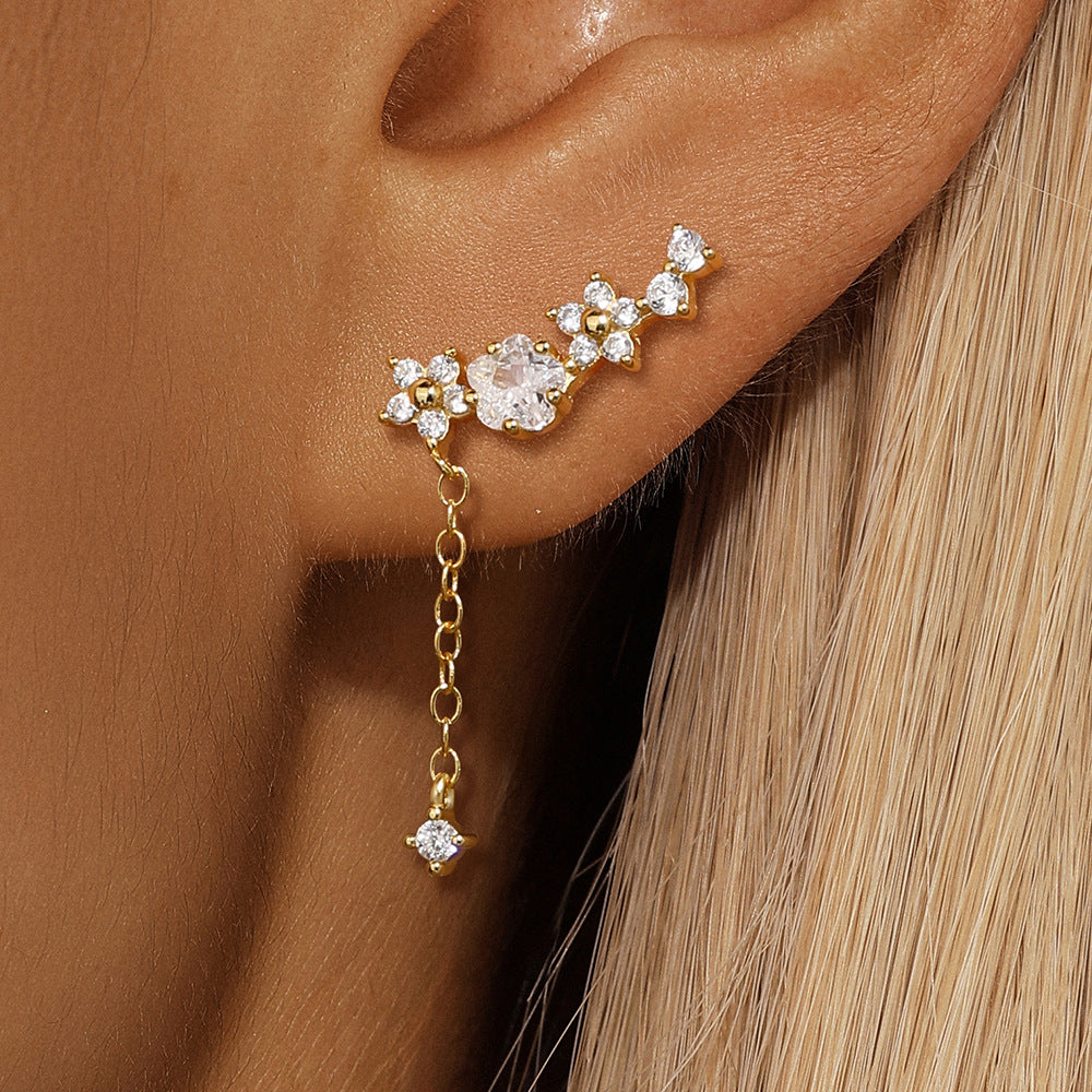 Model wearing floral zircon chain earrings, adding sparkle to the upper ear curve.