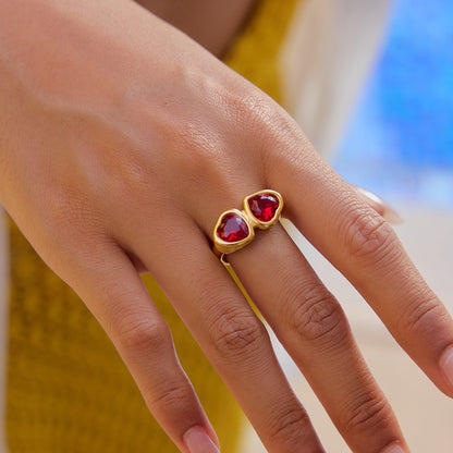 Romantic red heart gemstone ring worn by woman near poolside in summer light