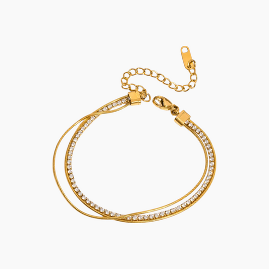 Gold bracelet with clear stones on a white background