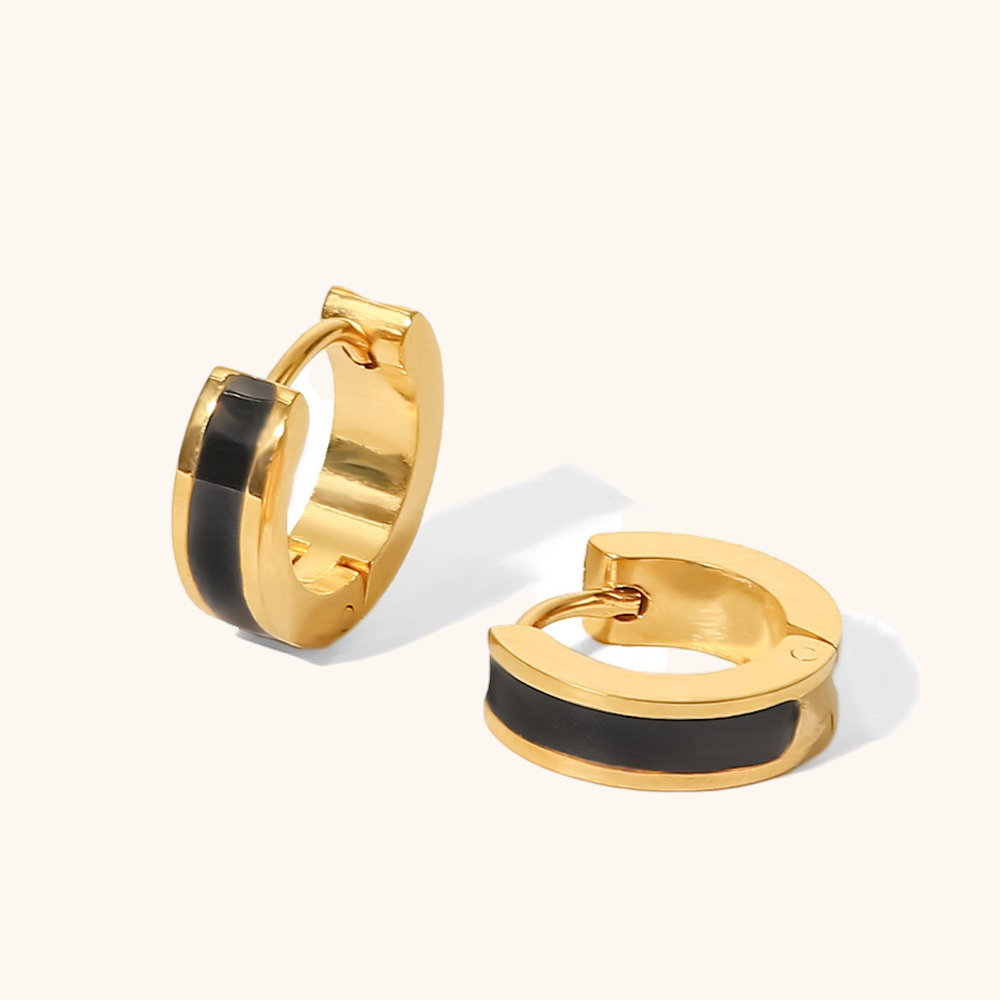 black GlowPop hoop earrings styled with sleek all-black evening wear