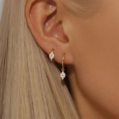 Gold-Plated Floral Charm Hoops – These gold-plated hoop earrings with a dainty floral charm are a chic addition to any jewelry collection. A must-have for those who love understated ele