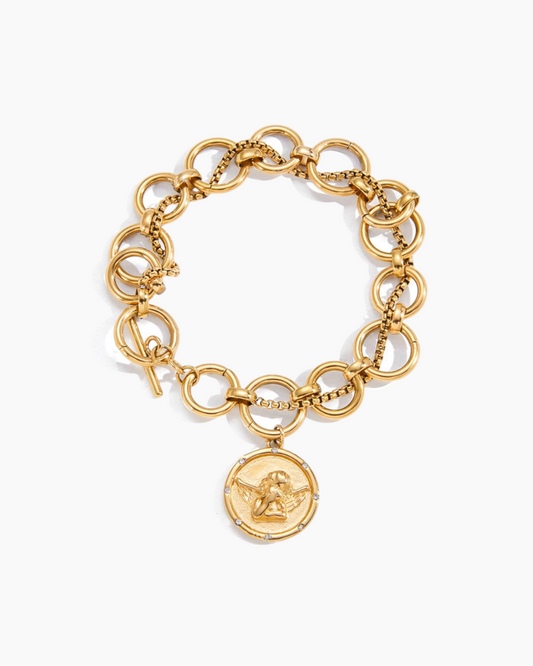 Gold chain bracelet with a circular pendant on a white background