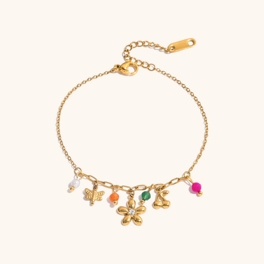 dainty bracelet with flower, butterfly, and cherry charms