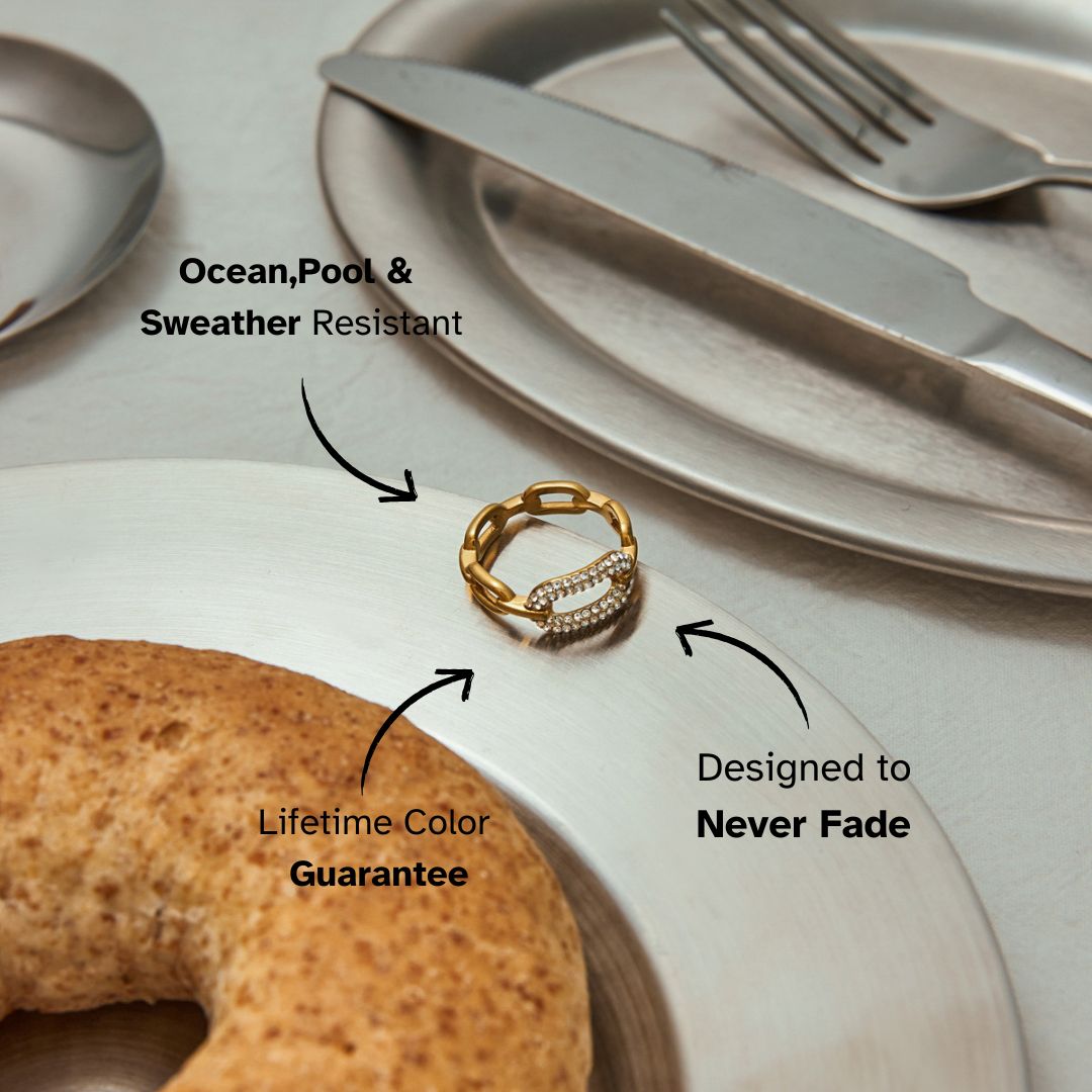 Dainty crystal chain ring styled elegantly on flatware for minimal table décor aesthetic.