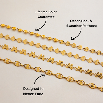 Layered gold chain necklaces with butterfly details styled on tanned skin