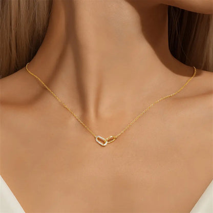 Model wearing a gold crossover zirconia necklace, adding elegance to their outfit.