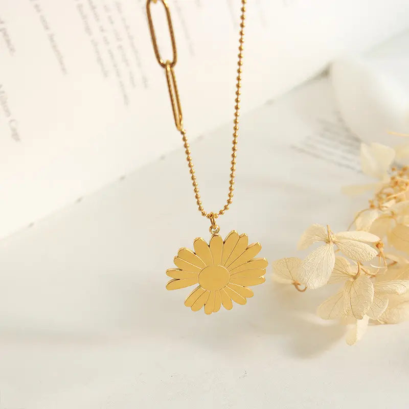 Detailed view of the gold daisy pendant necklace with a smooth finish and minimalist design, perfect for everyday wear.