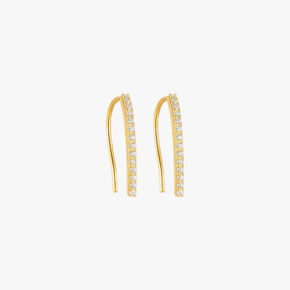 A pair of gold curved earrings with diamonds.