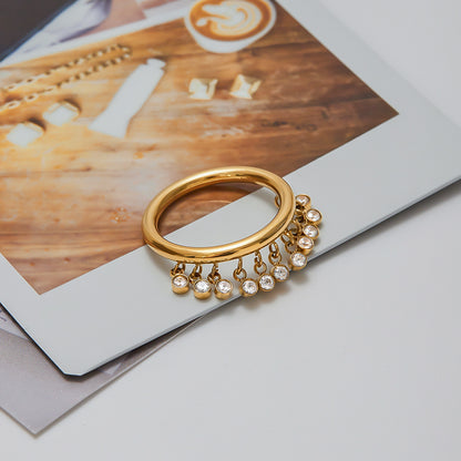 Gold charm ring on finger styled
