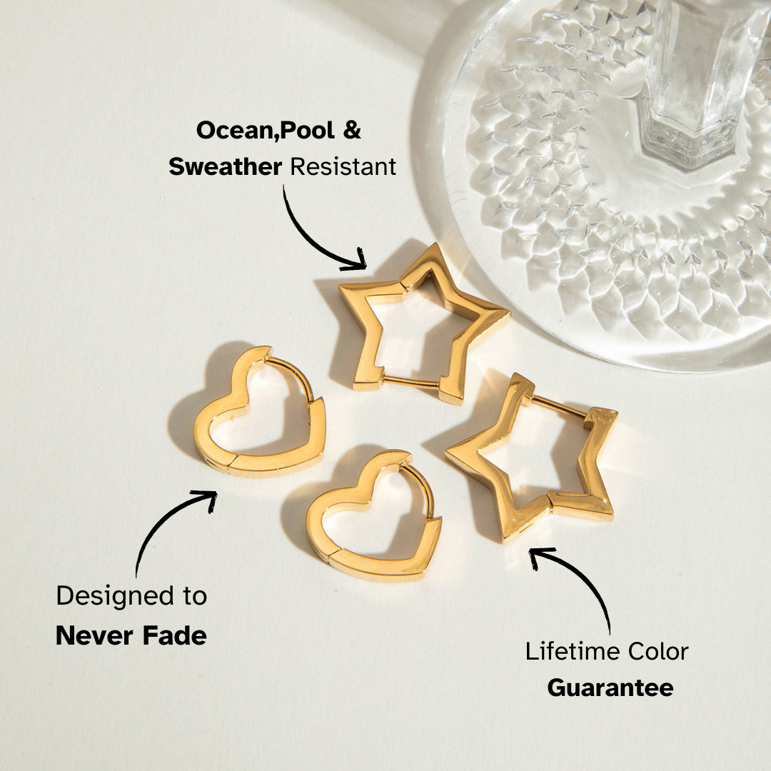 Two pairs of geometric gold hoops — heart and star shaped — photographed in soft natural light