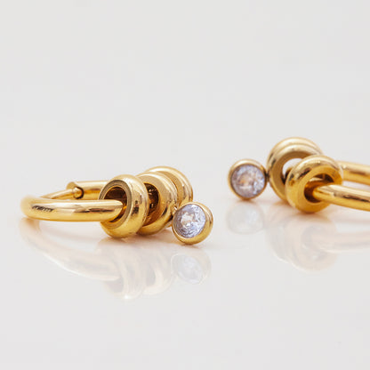 Minimalist gold earrings with lifetime color guarantee on display