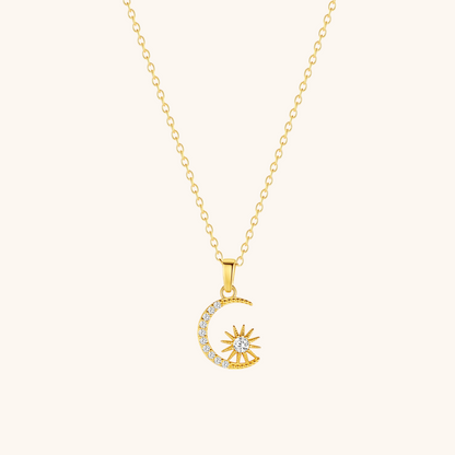 Dainty celestial charm necklace with moon and star on soft beige surface, minimal style.