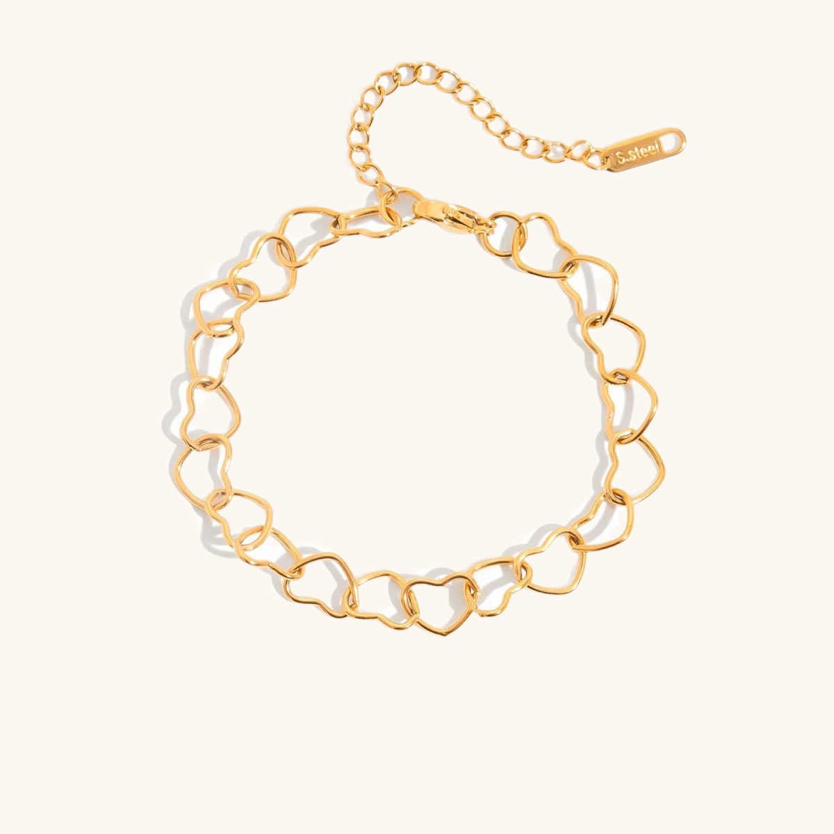 Minimalist gold heart chain bracelet in flatlay view on neutral background