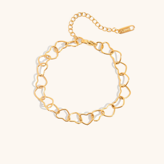 Minimalist gold heart chain bracelet in flatlay view on neutral background