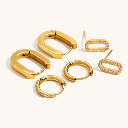 Close-up of gold oval pavé stud earrings with sparkling CZ stones