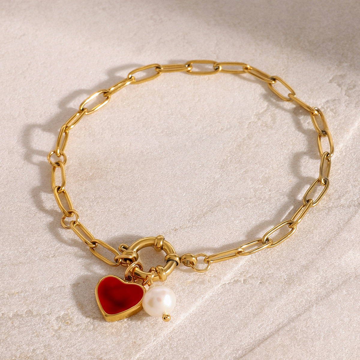Chunky gold paperclip chain bracelet with red heart and pearl accents