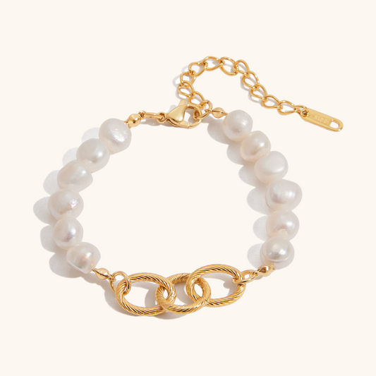 Close-up of rope twist gold links and freshwater pearls on white background