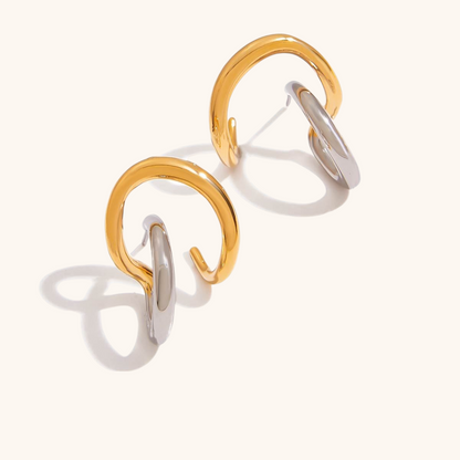 Product photo of mixed-metal open hoop earrings with intertwined gold and silver rings