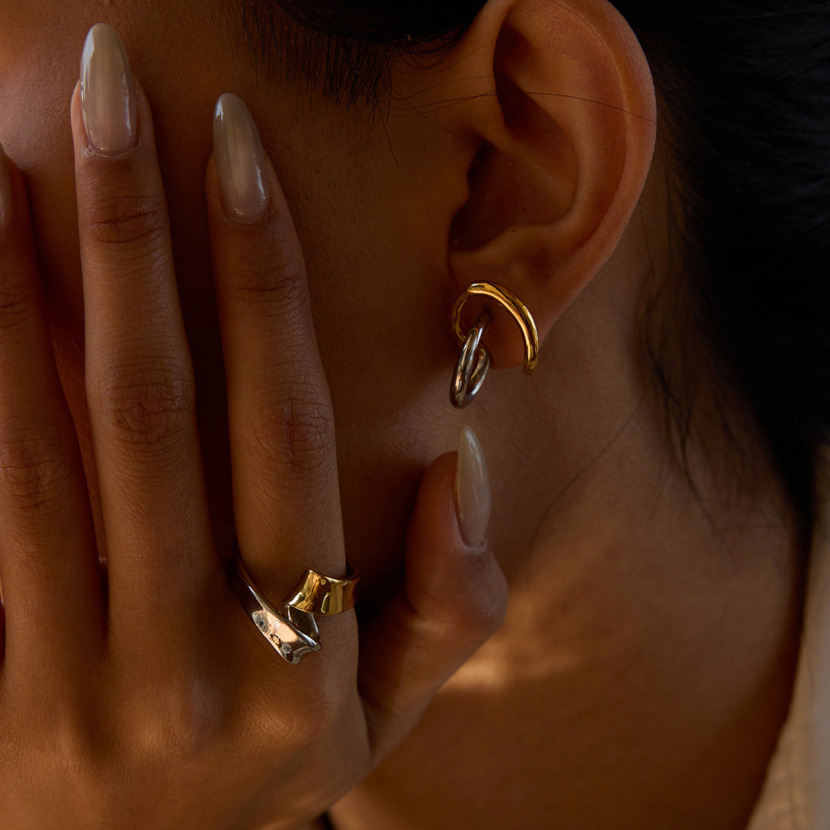 Gold and silver knot ring paired with mixed metal earrings