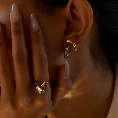 Gold and silver knot ring paired with mixed metal earrings