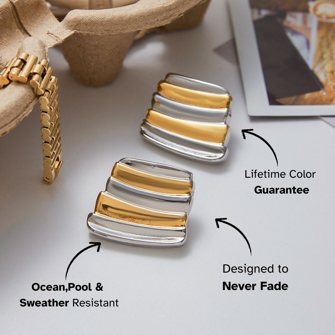 bold layered bar earrings in gold and silver finish resting on table