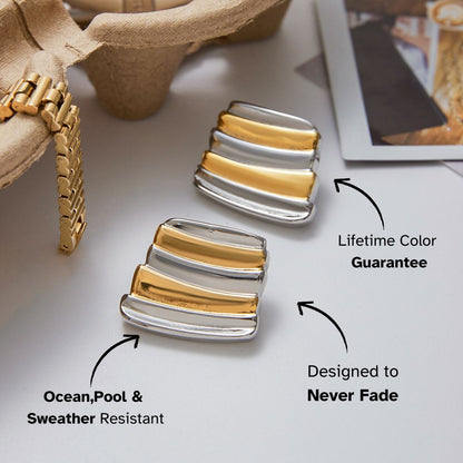 bold layered bar earrings in gold and silver finish resting on table