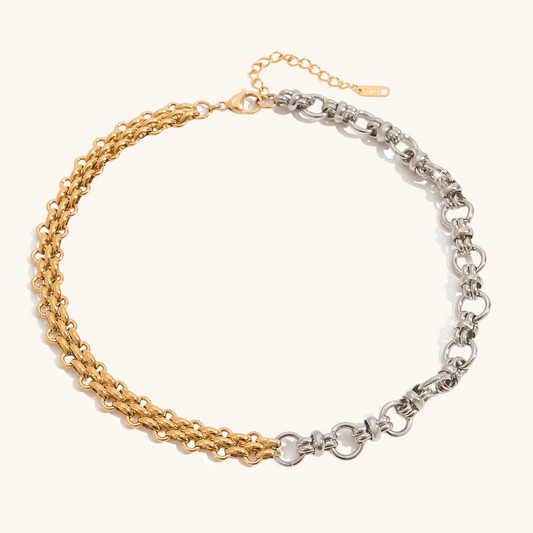 Close-up of model wearing multi-strand layered necklace in gold and silver metals with elegant white outfit and jewelry set.