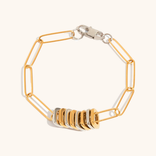 Fashionable link bracelet with alternating gold and silver ring elements, perfect for everyday wear or stacking.