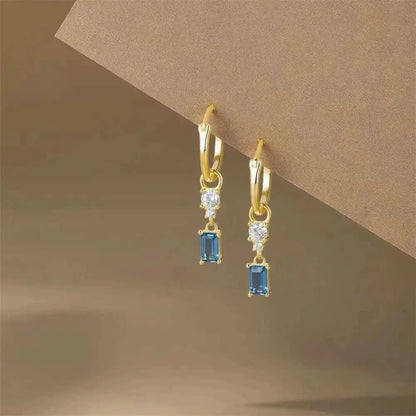 Gold hoops with dangling blue charms—perfect for adding elegance to your everyday style.