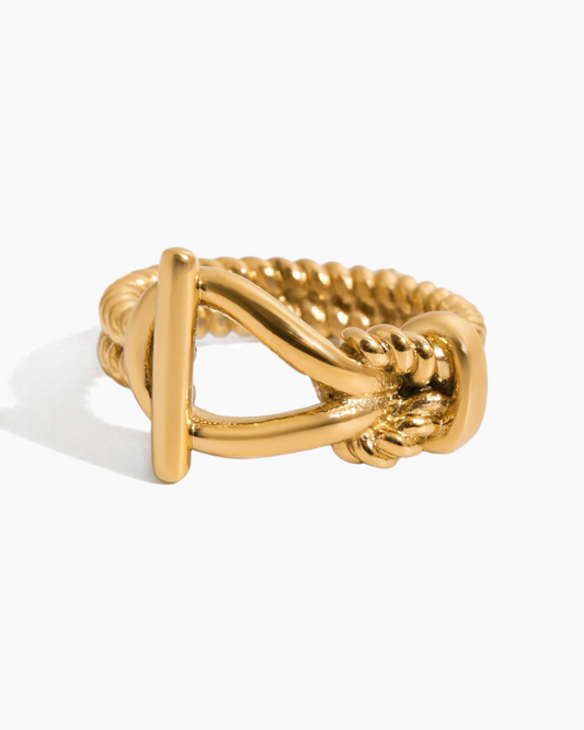 Gold ring with a unique design on a white background