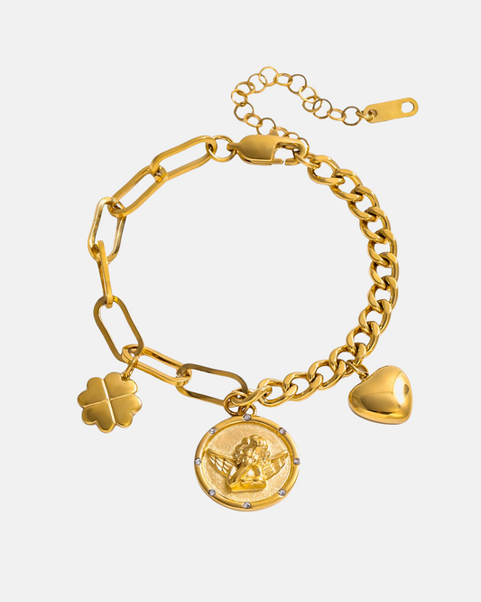 Gold bracelet with charms on a light beige background