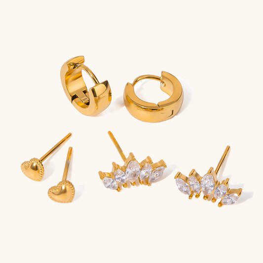 gold chunky huggie hoop earrings on marble surface